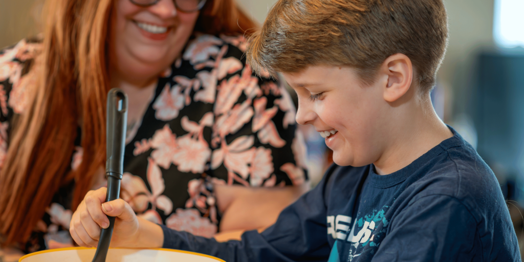 Child cooking with his mom in the home they purchased with the land trust